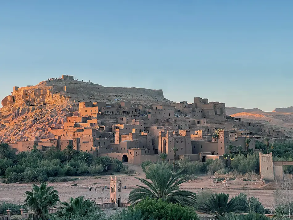 Ait Ben Haddou’s clay-built village at sunset, a popular budget winter destination set beside palm groves in southern Morocco.