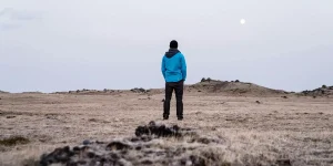 Solo traveler enjoying a scenic mountain view during a hike