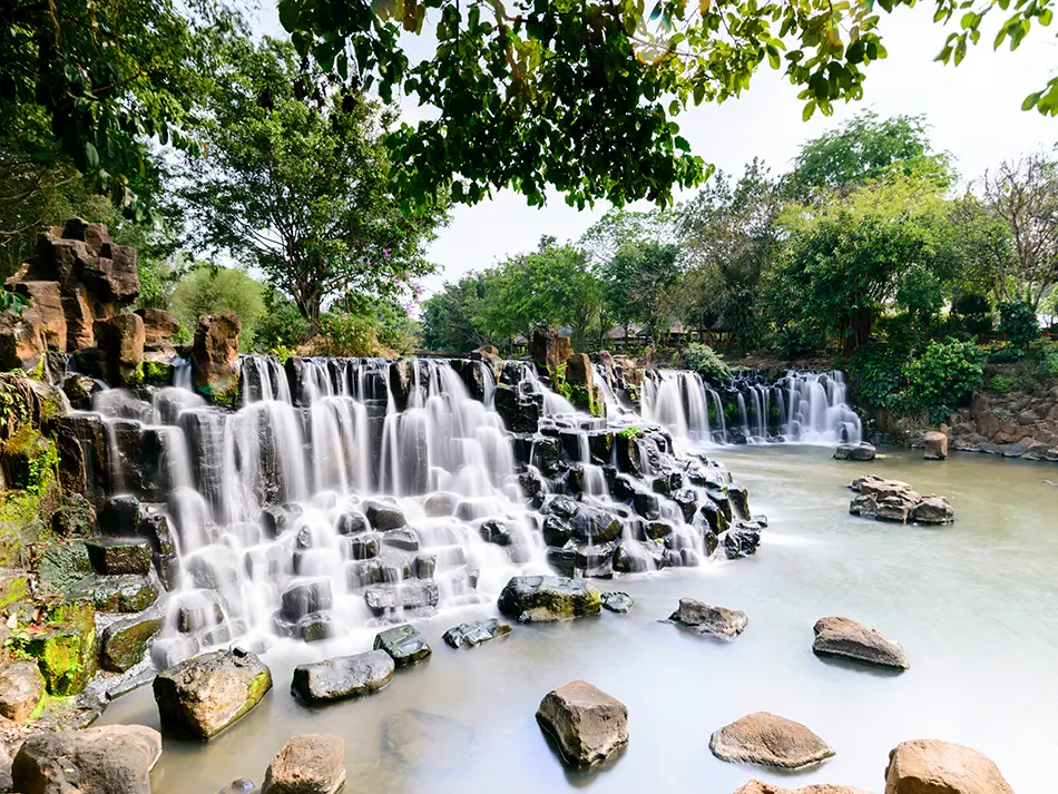 Giang Dien Waterfall cascading over volcanic rock terraces in Dong Nai, a popular picnic spot in South Vietnam