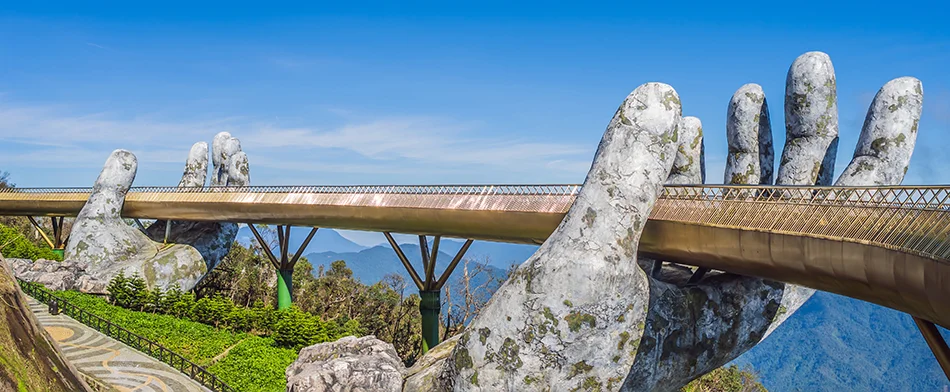 Ancient-looking hands holding the Golden Bridge in Ba Na Hills, one of the best bridges in Vietnam for unique design and photos