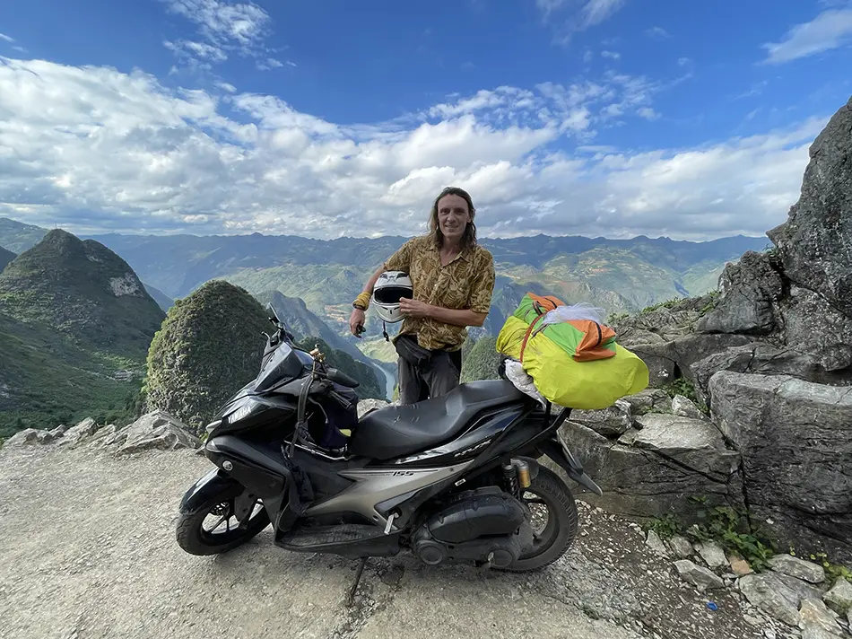 Solo traveler on a motorbike in the mountains of Northern Vietnam, a classic choice for scenic road trips.