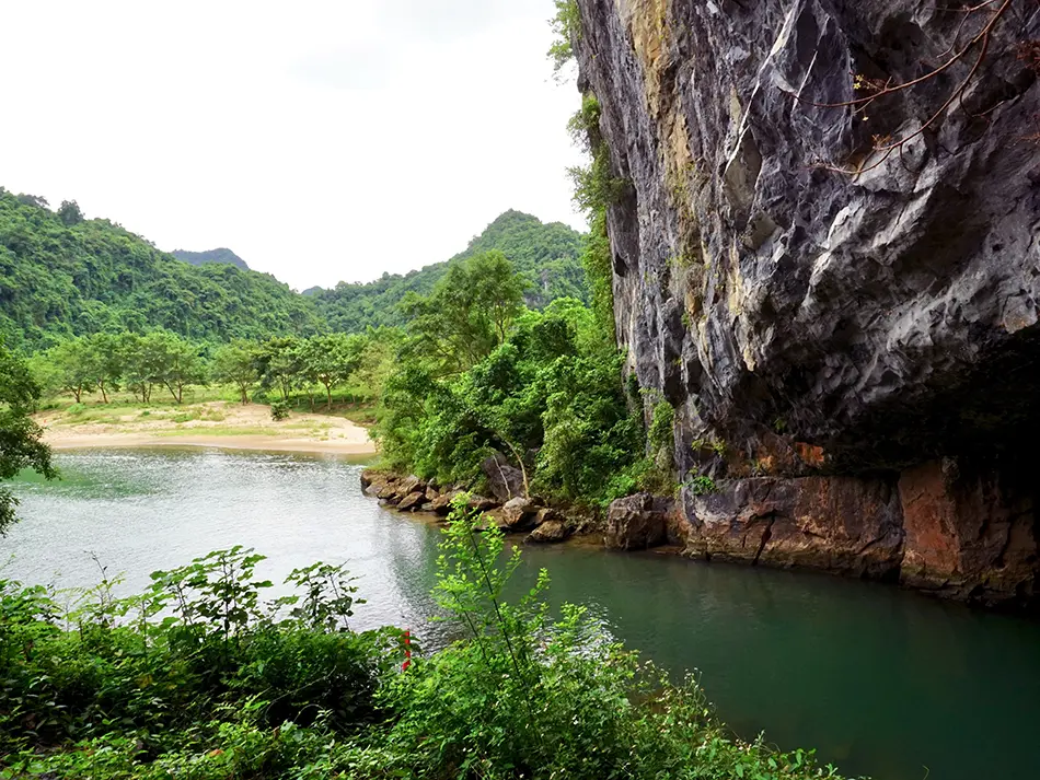 View from inside Phong Nha Cave looking out to the jungle and river, a hidden UNESCO site in Central Vietnam