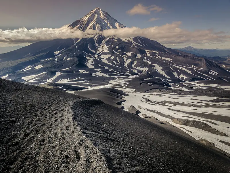 Volcanic ridges and snow patches in Kamchatka, perfect for cool climate vacations