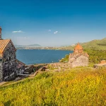 Stone Sevanavank monastery above Lake Sevan at golden sunrise, on of the best things to do in Sevan.