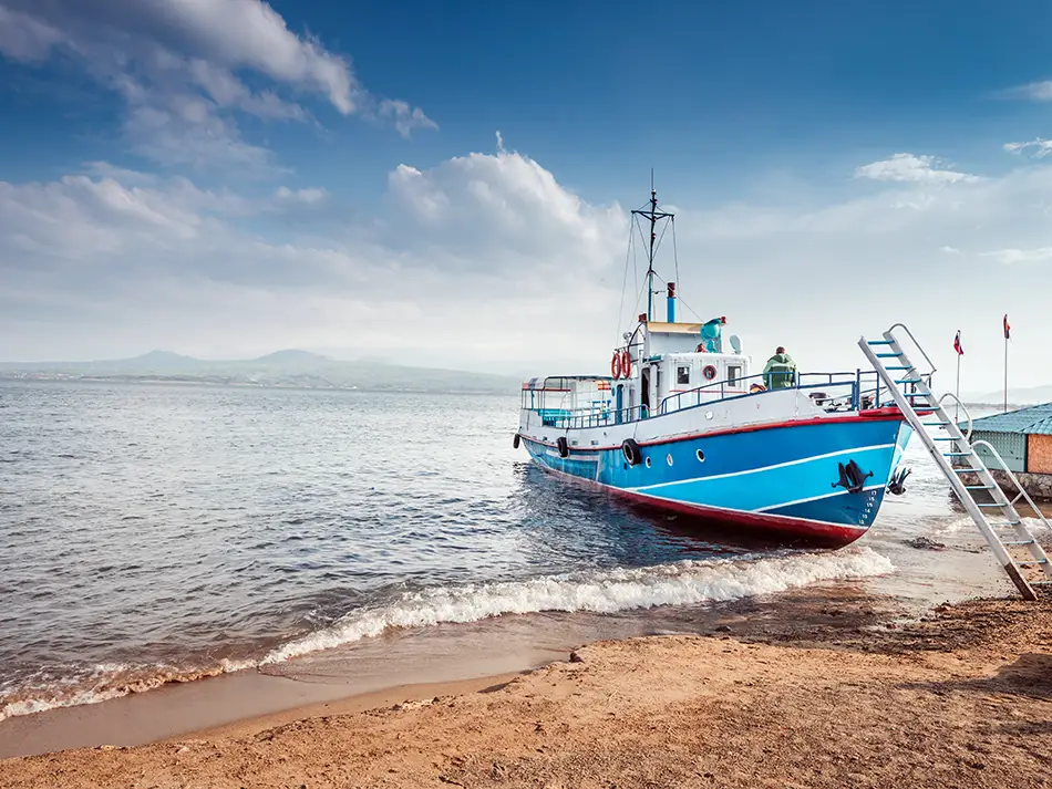 Blue fishing boat moored on the lake