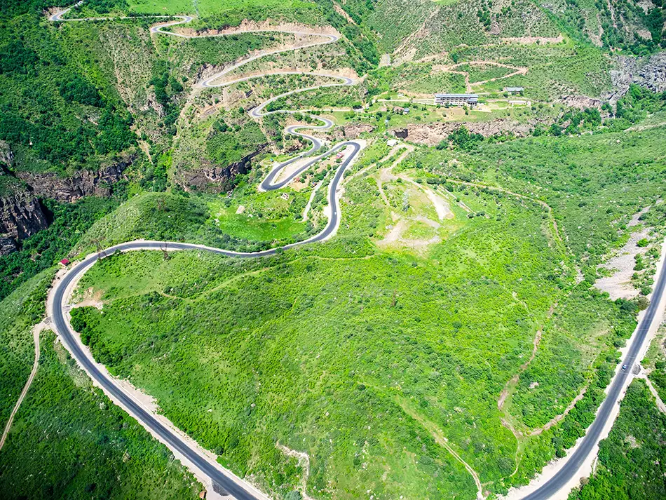Aerial view of steep switchback road descending into Vorotan River Canyon.