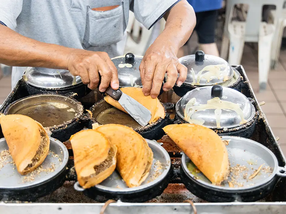 Apam balik folded pancake with crushed peanuts and corn, a must-try Malaysian treat.