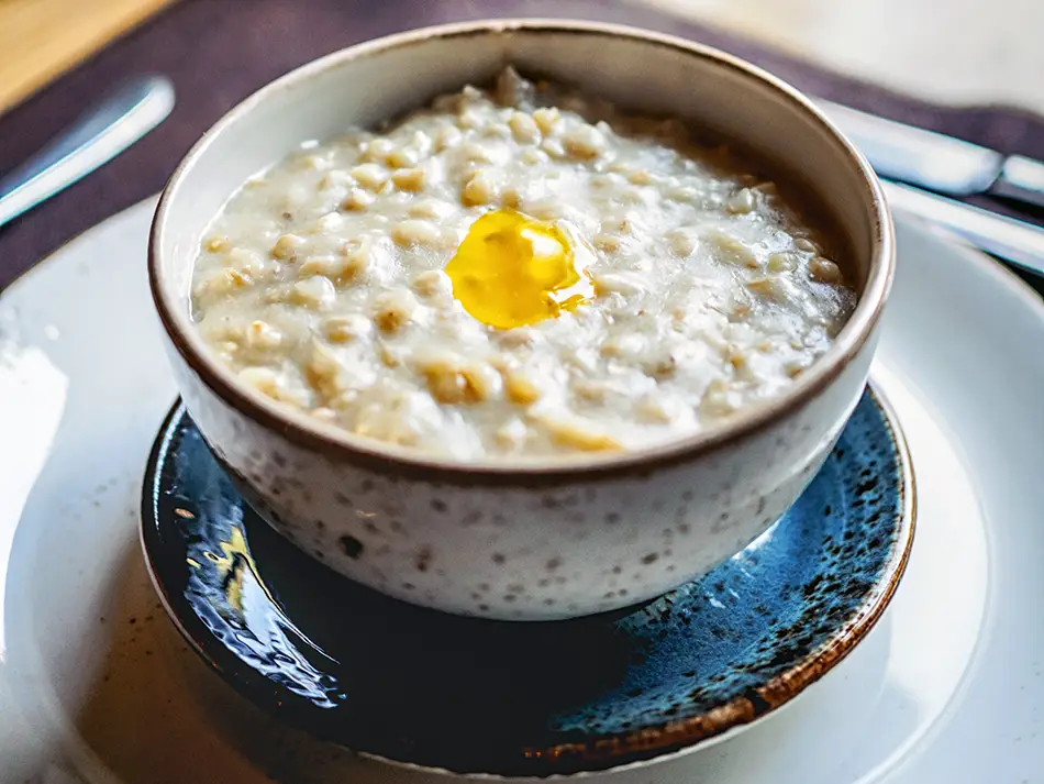 Thick bowl of harissa, a slow-cooked porridge of wheat and meat, highlighting Armenian culinary heritage.