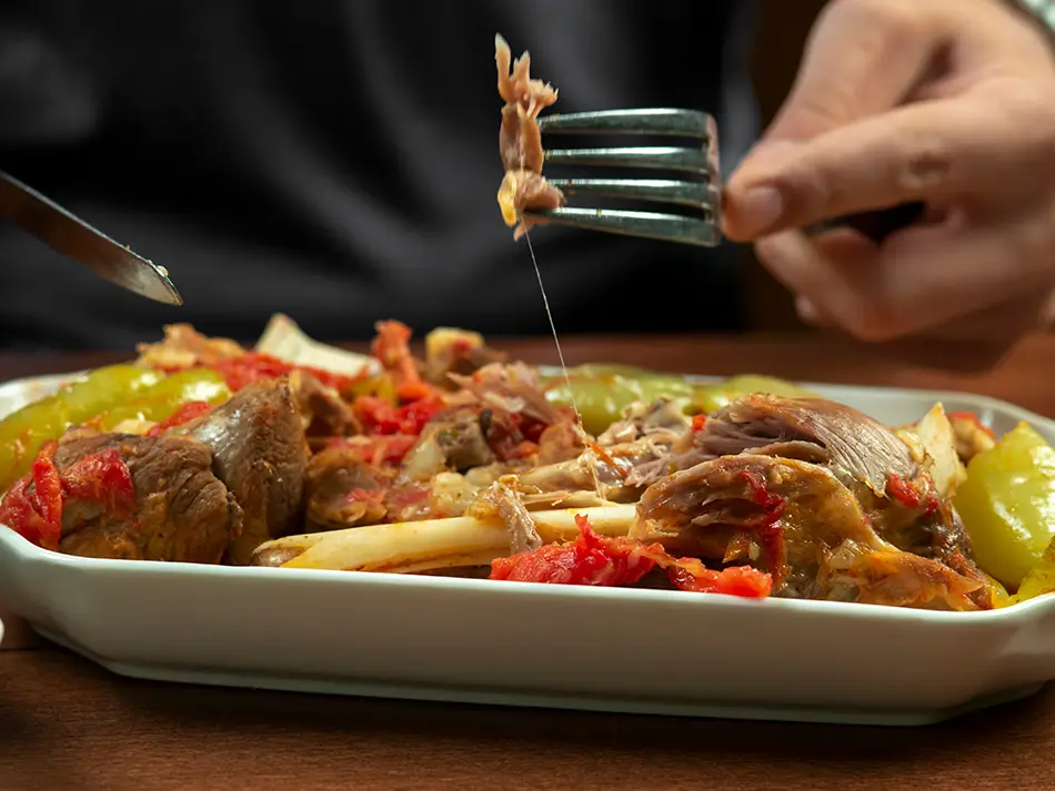 Colorful platter of khashlama stew with tender lamb and vegetables, a popular dish in Armenian cuisine.