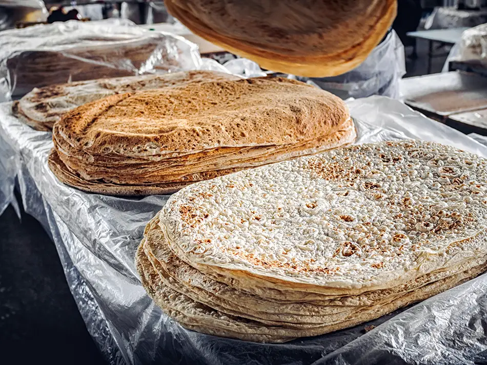 Freshly baked Armenian lavash flatbread stacked in layers, an essential part of Armenian cuisine.