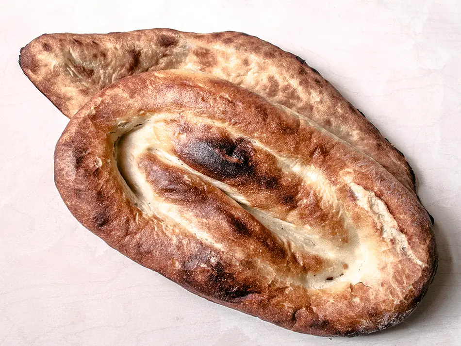 Oval-shaped matnakash bread with golden crust, a beloved item in traditional Armenian bakeries.