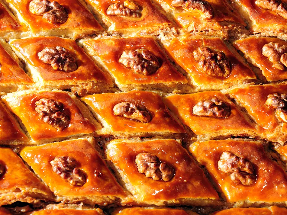 Rich and flaky Armenian pakhlava dessert with walnuts and syrup, popular in Armenian sweet dishes.