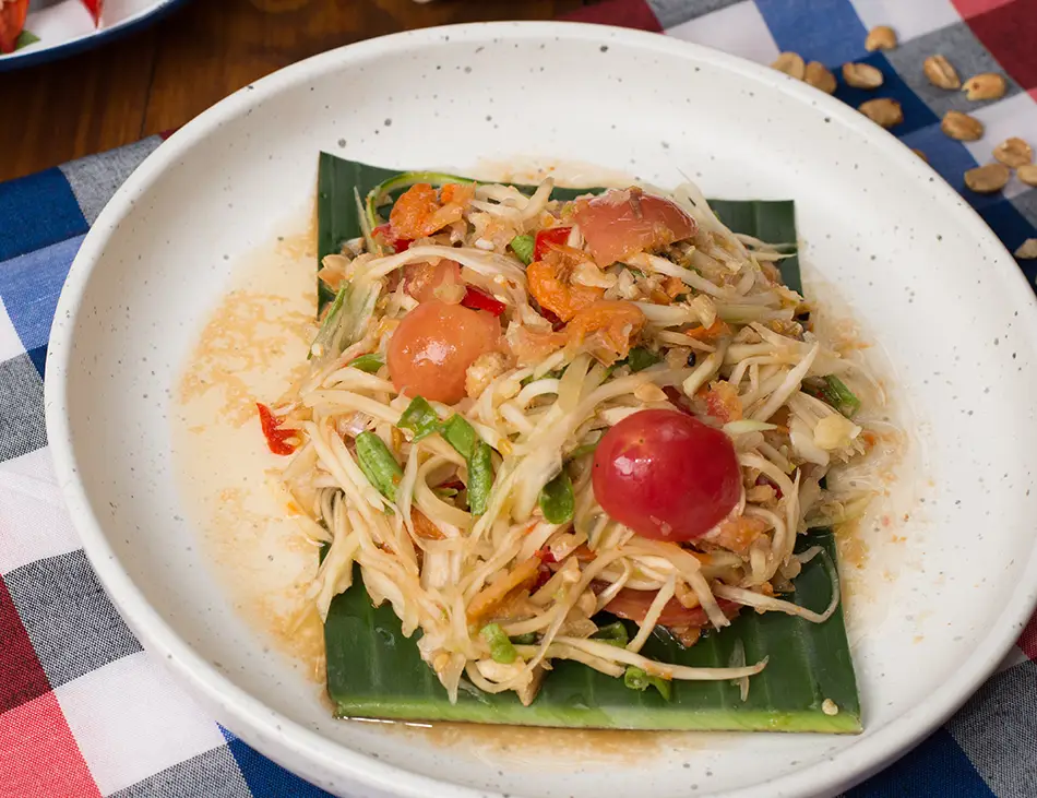 Bok L’hong, Cambodian green papaya salad with chili, lime, and prahok, a tangy street food and essential best food in Cambodia dish
