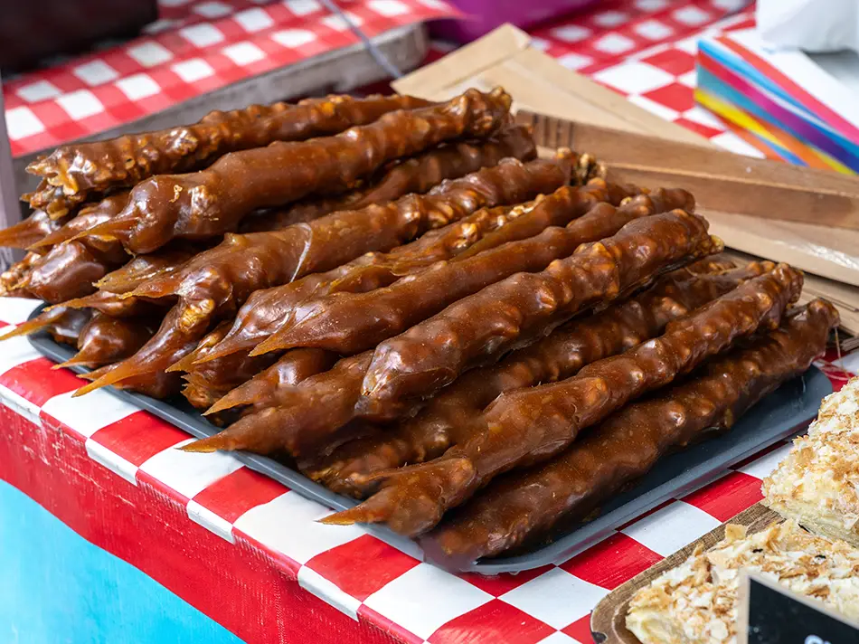Best food in Georgia: churchkhela nut strings laid out at a Kakheti market stall.