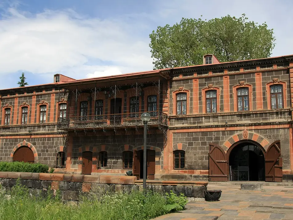 Dzitoghtsyan Museum courtyard with carved tufa and balconies