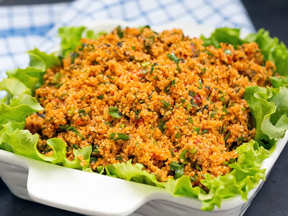 Eech, a fresh Armenian bulgur salad with herbs, tomatoes, and spices served on lettuce