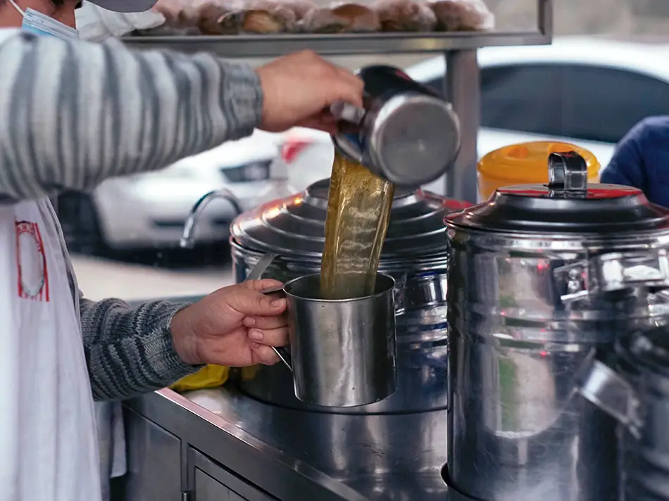 What to drink in Peru: steaming emoliente poured from a street cart in Lima.