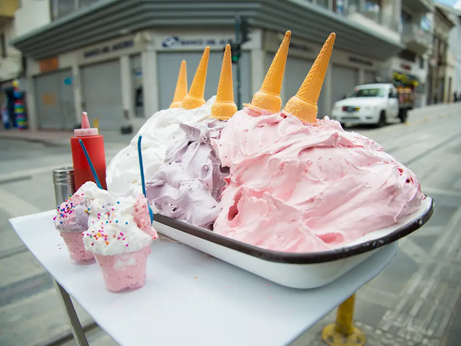 Famous Ecuador desserts include espumilla, a fluffy guava meringue swirled into a cone.