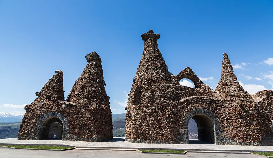 Top Attractions in Goris include a stone arch memorial with bells near town.