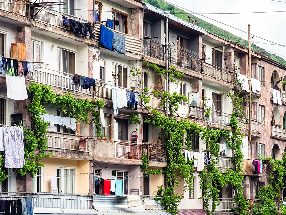 Vine-covered apartment balconies in a residential block in Goris, Syunik.