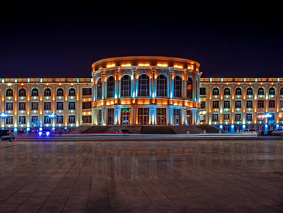 Vardanants Square illuminated at dusk, showcasing city life and best things to do in Gyumri.