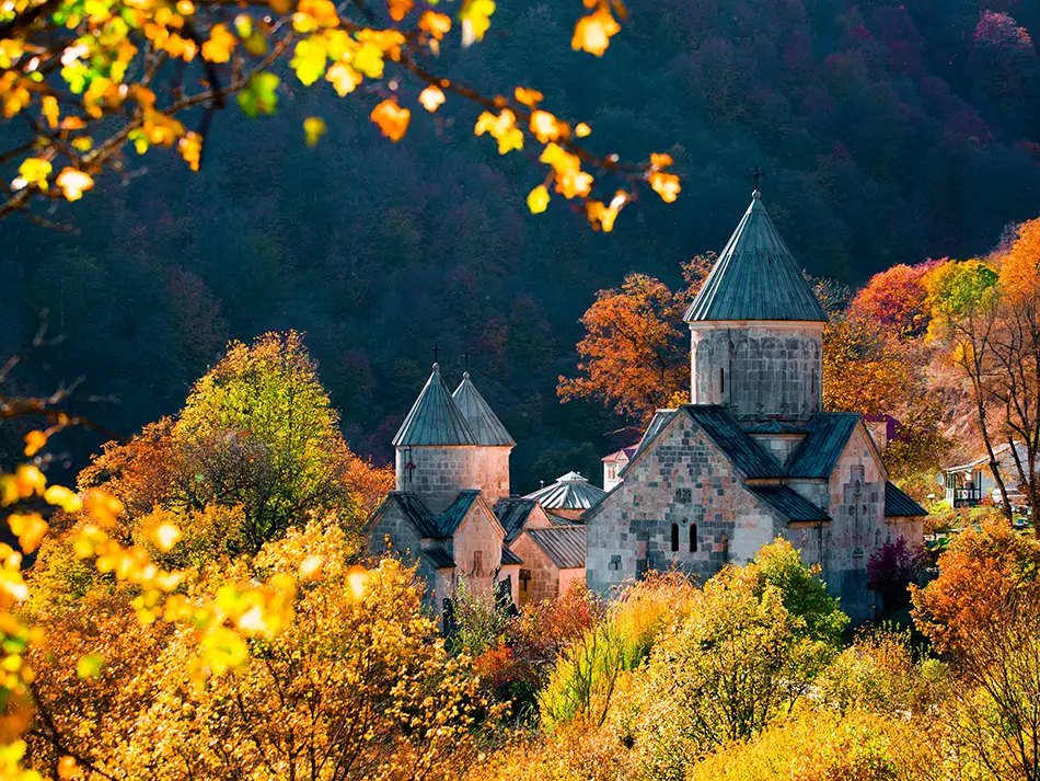 Haghartsin Monastery amid autumn forest, a scene that shows why visit Dilijan.
