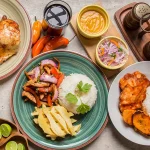 Best food in Peru: overhead flat lay of lomo saltado, pollo a la brasa and escabeche de pollo