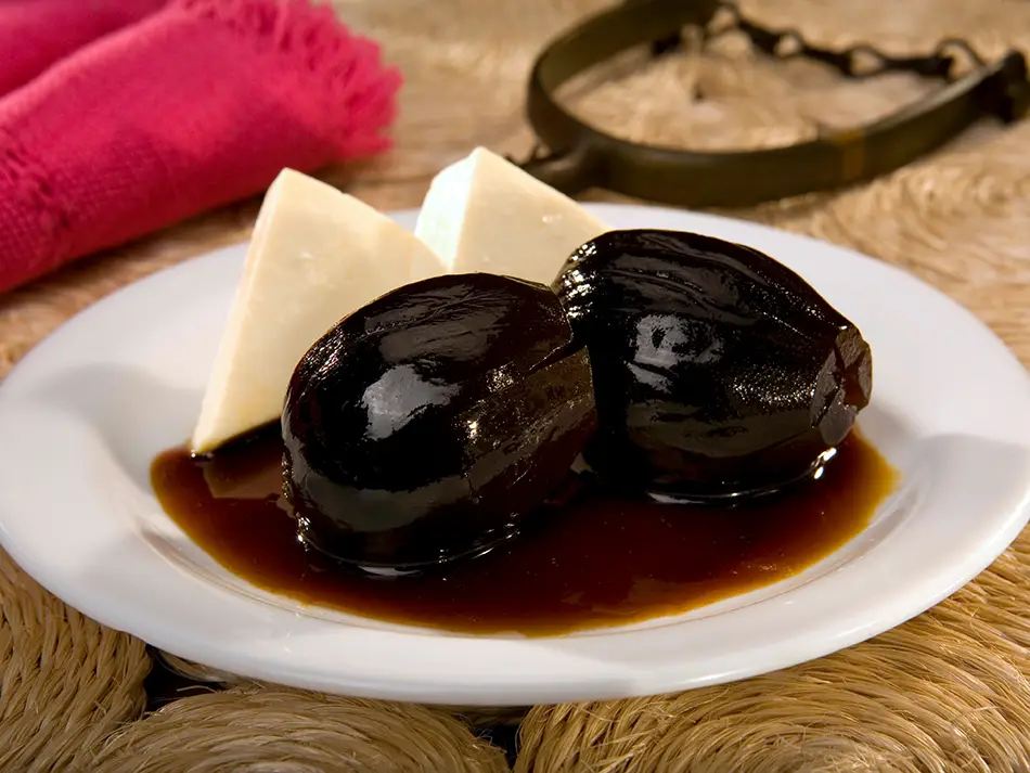 Figs in panela syrup served with slices of fresh queso fresco.