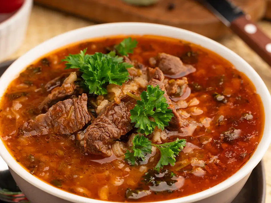 What to eat in Georgia: kharcho beef soup topped with cilantro.