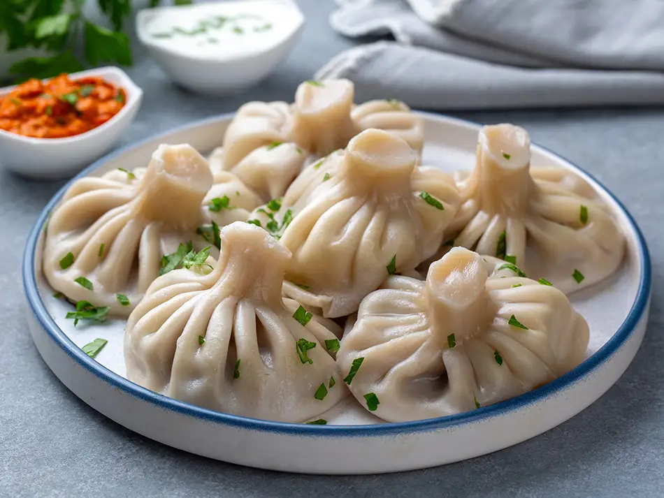 Best food in Georgia: khinkali dumplings on a plate in a Tbilisi restaurant.