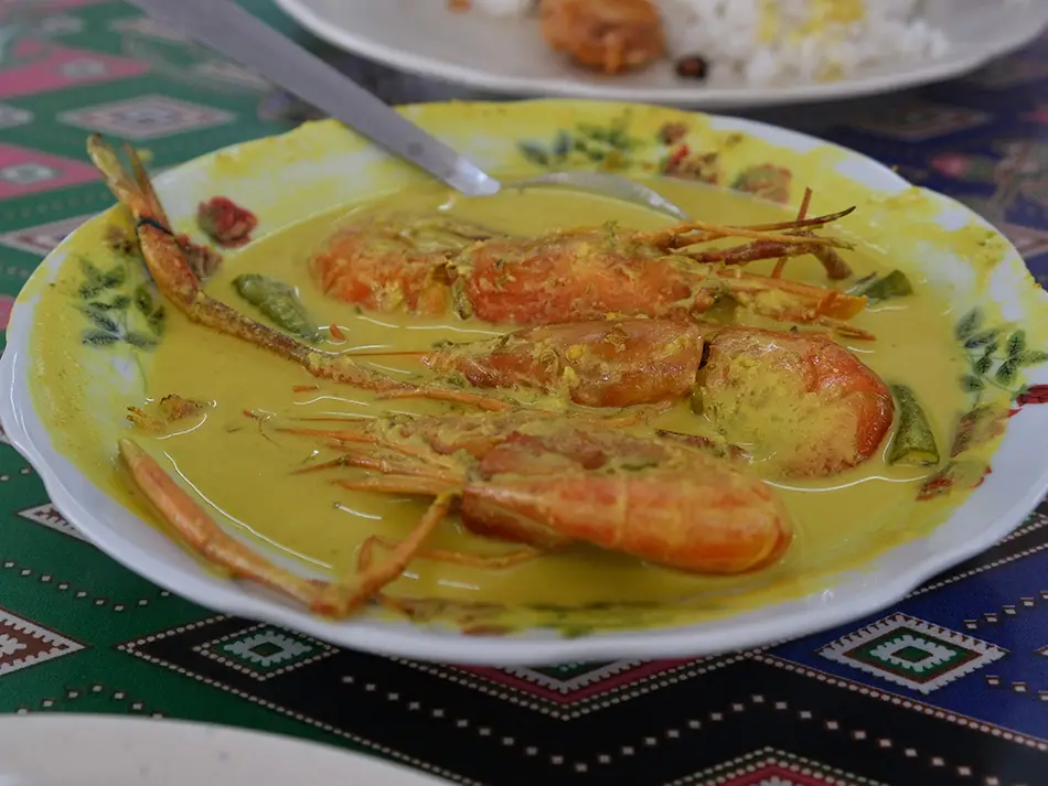Creamy masak lemak cili padi with prawns in coconut gravy, a rich example of foods to try in malaysia.
