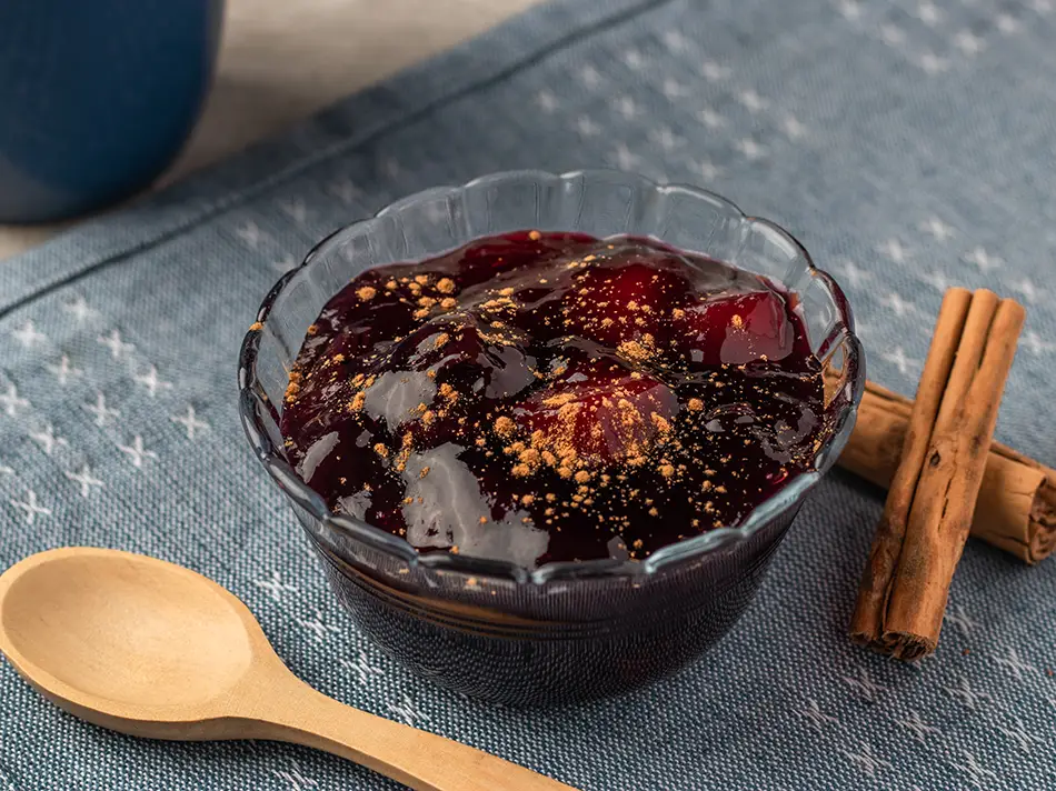 Mazamorra morada purple corn pudding with cinnamon and fruit, served in Lima.