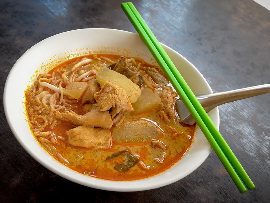 Mee rebus noodles in thick sweet potato gravy with egg and fried tofu.