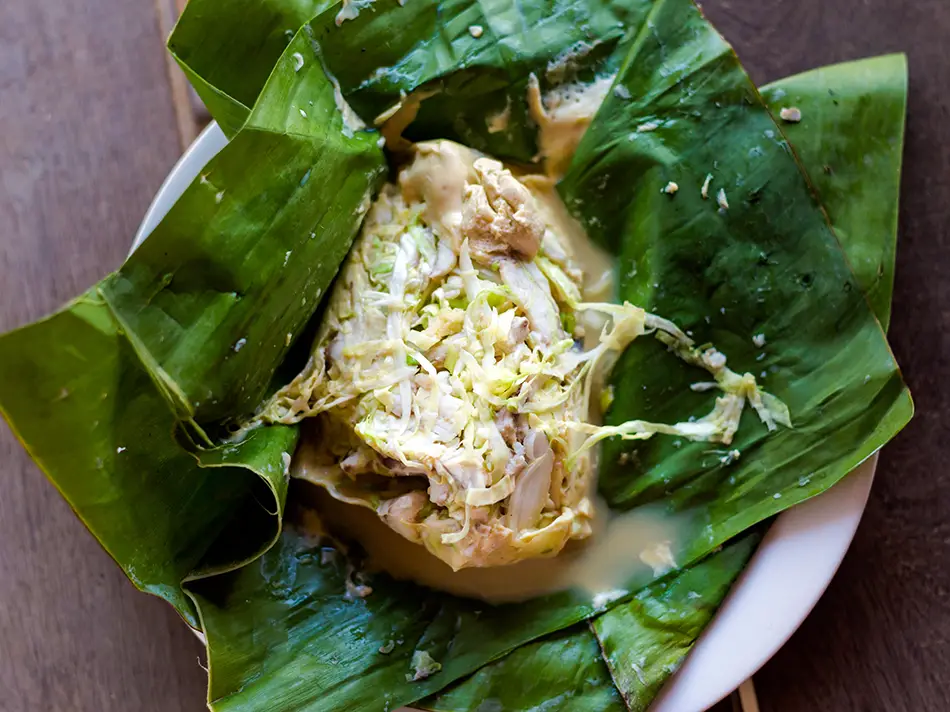 What to eat in Laos: mok pa fish steamed in banana leaf with  lemongrass.