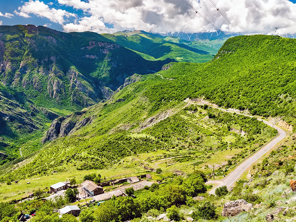 Green cliffs and deep-cut ridges of the Vorotan Gorge seen from the Halidzor area.