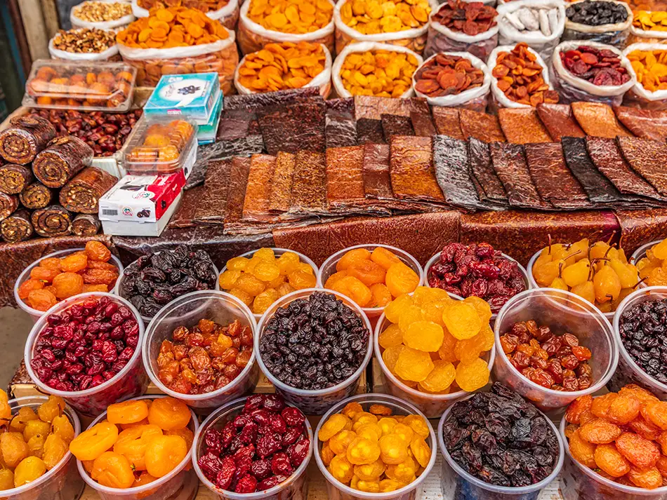 Colorful market stall in Gyumri selling dried fruits, berries, and fruit leather.