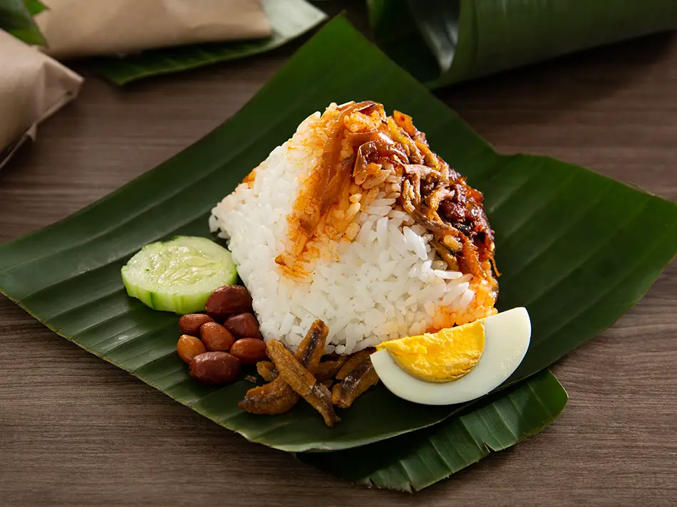 Fragrant nasi lemak with sambal, fried anchovies and cucumber, a must-try foods in Malaysia.