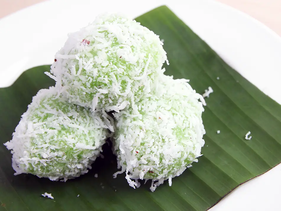 Onde-onde - glutinous rice balls filled with molten palm sugar and rolled in coconut.