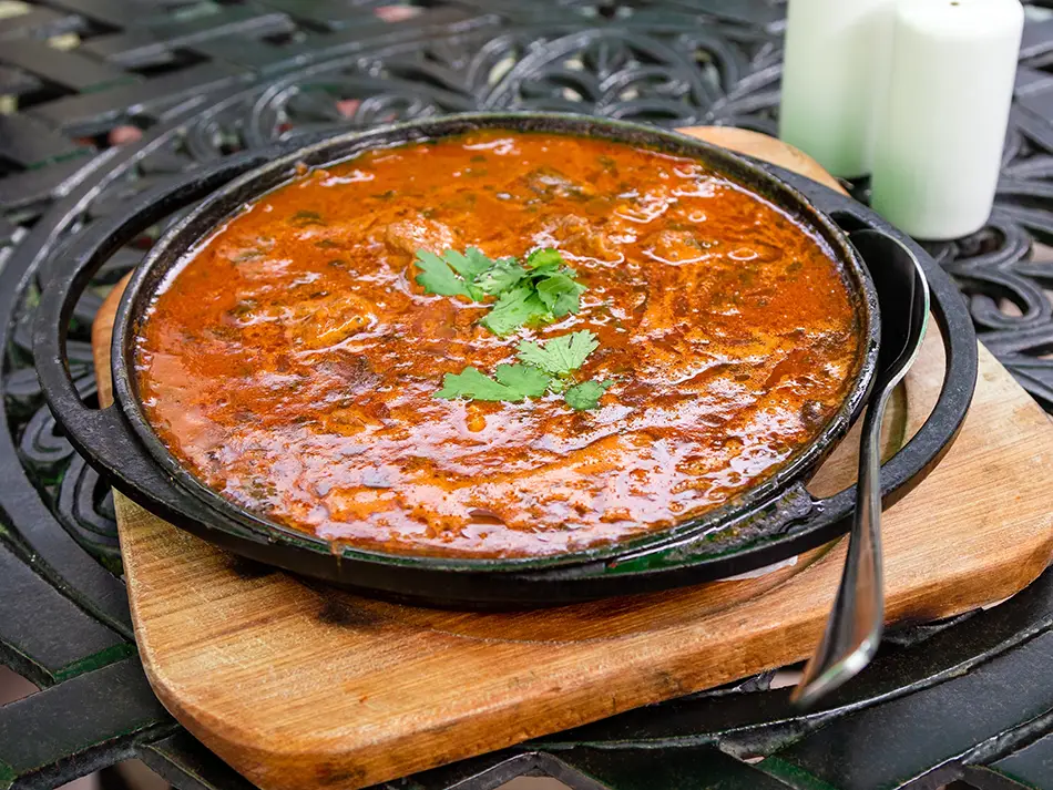 Must-try foods in Georgia: ostri spicy beef stew with tomatoes and herbs.