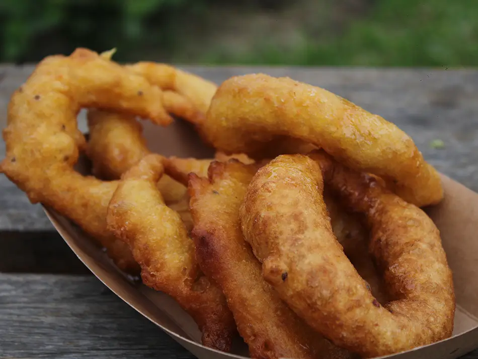 Sweet potato–squash fritters glazed with chancaca syrup in Lima — best food in Peru.