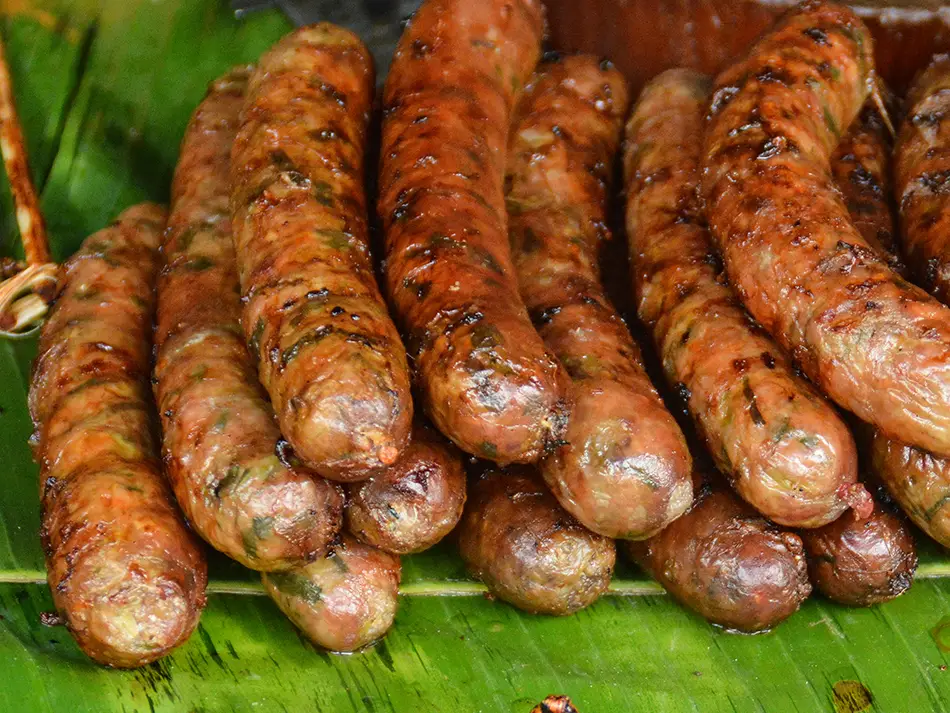 National dishes of Laos: sai oua pork sausage grilled and sliced, packed with lemongrass and herbs.