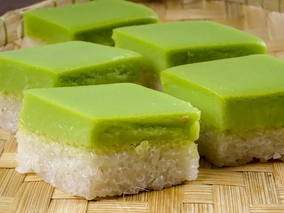 Seri muka steamed cake with pandan custard and coconut glutinous rice, part of best Malaysian desserts.