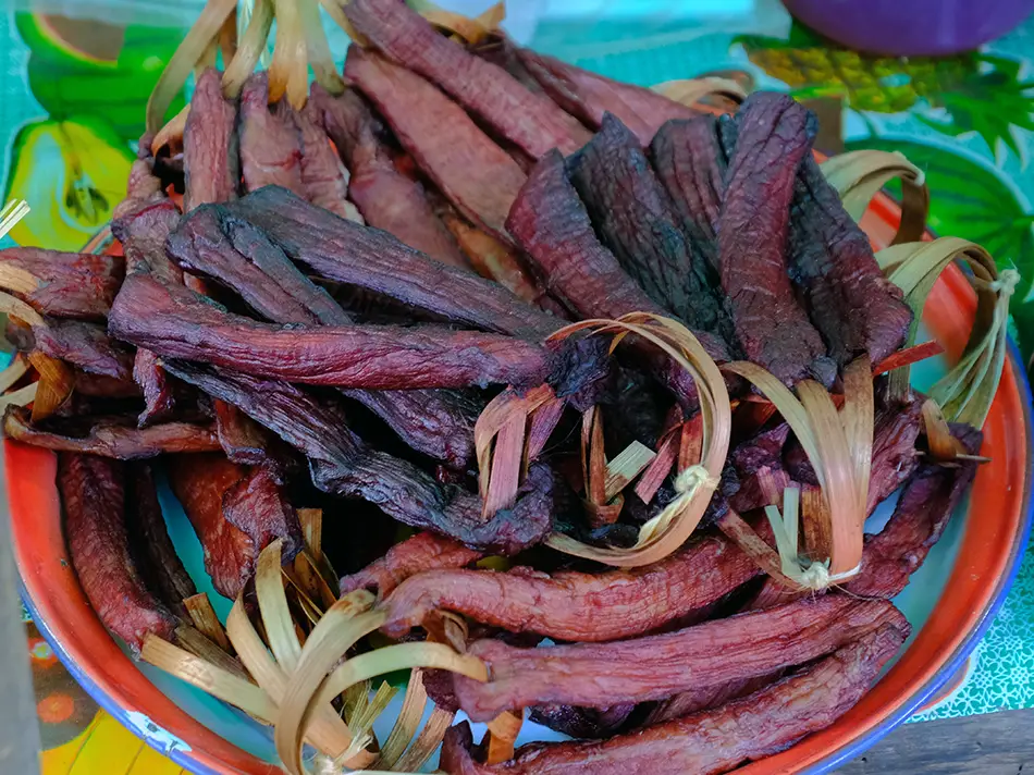 Sun-dried beef jerky strips tossed with sesame and spices, served warm for a chewy snack.