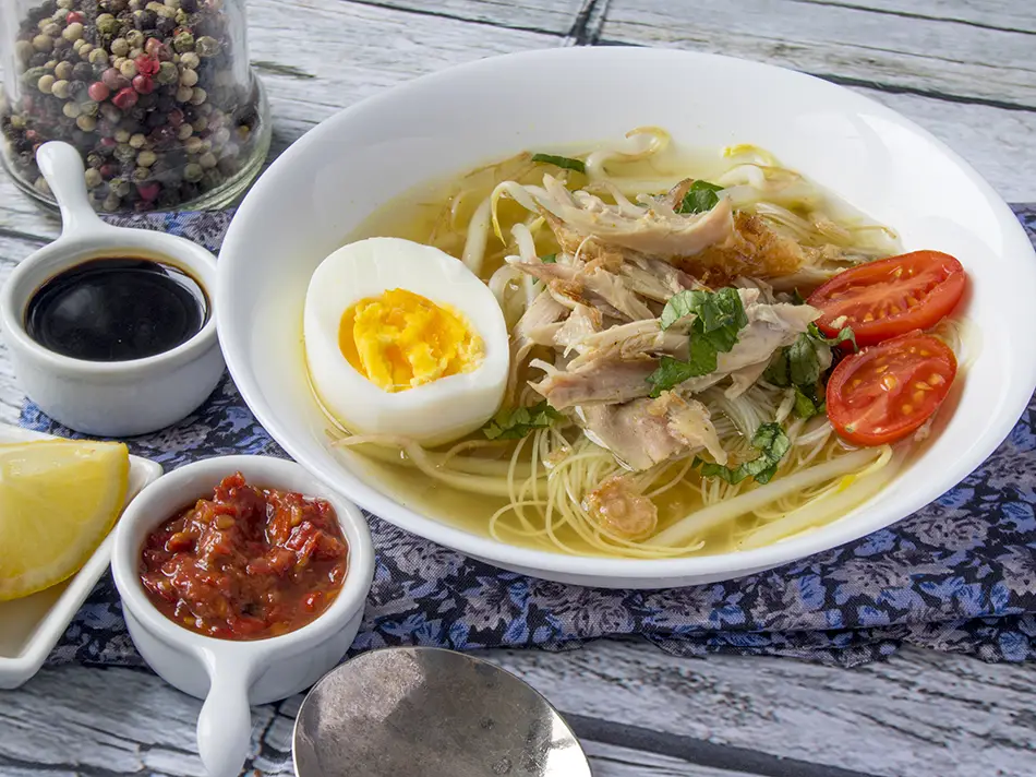Soto ayam chicken soup with bean sprouts and fried shallots, a warming example of local food in Malaysia.