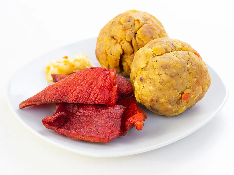 Tacacho con cecina from Iquitos shows what to eat in Peru with plantain mash and smoked pork.