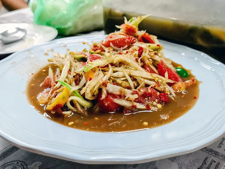 Tam mak hoong papaya salad with padaek, tomatoes and chilies pounded in a mortar — best food in Laos.