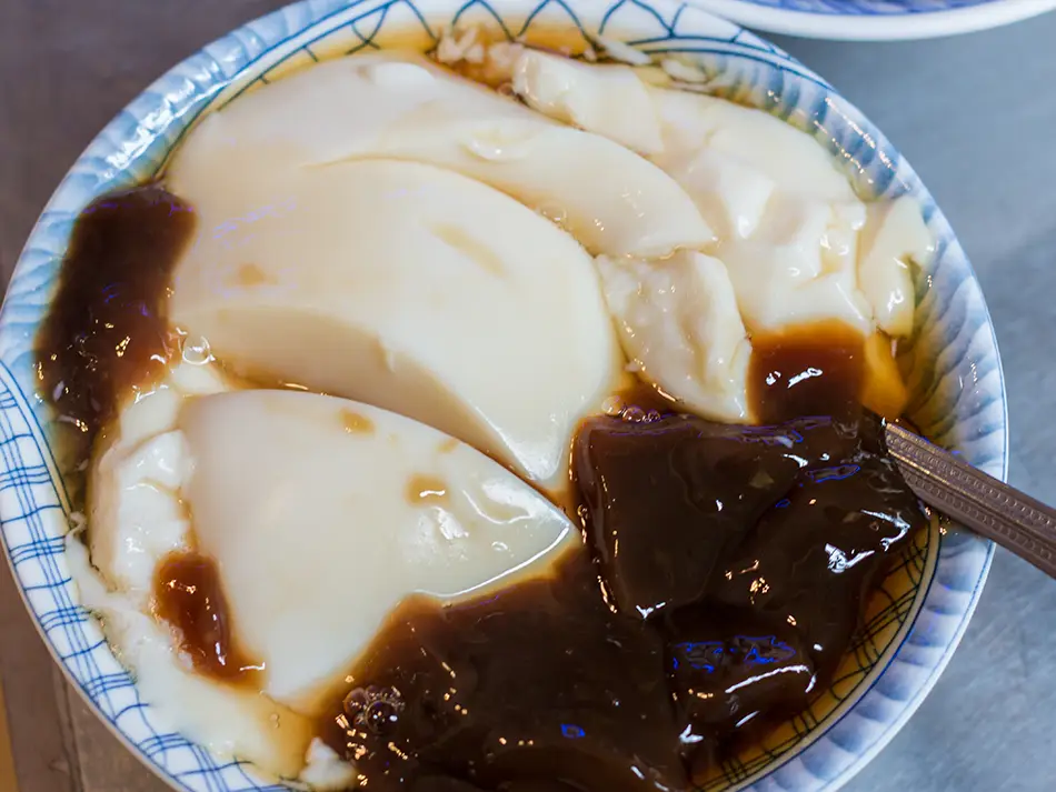 A plate of silky tau fu fa in ginger syrup.