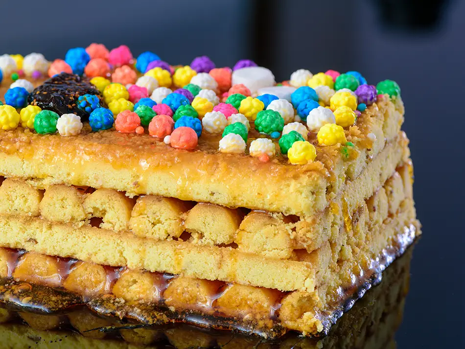 Turrón de Doña Pepa, anise cookie sticks layered with syrup and sprinkles in Lima.
