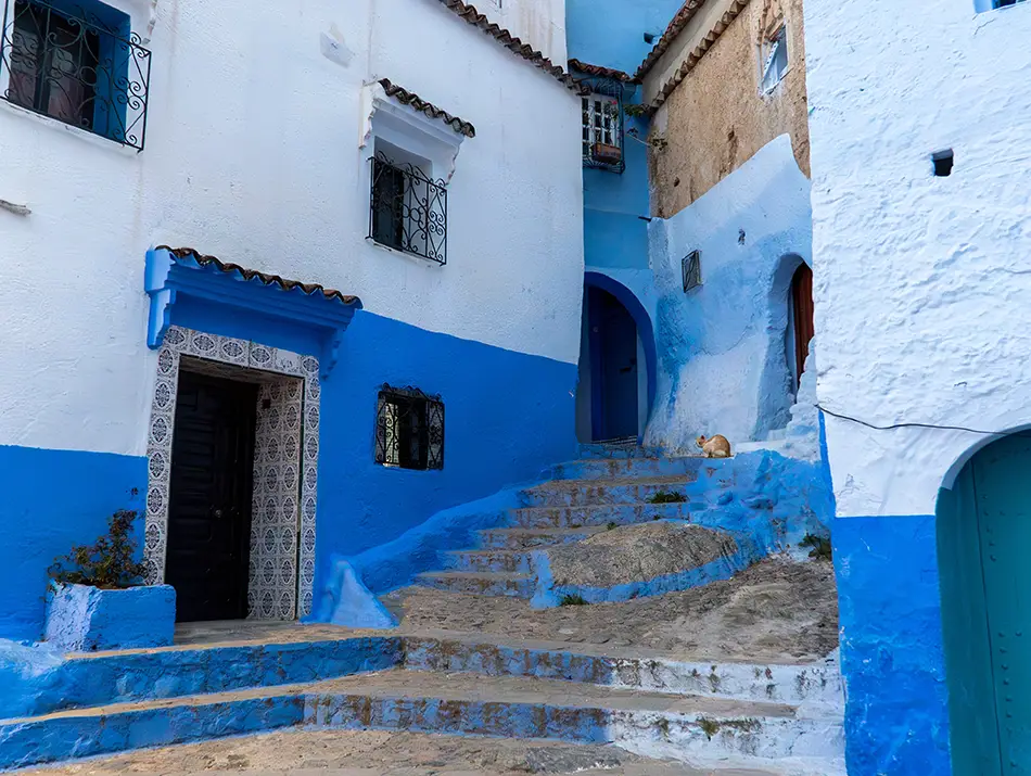 Unfinished painting on the blue wall showing Chefchaouen without the hype