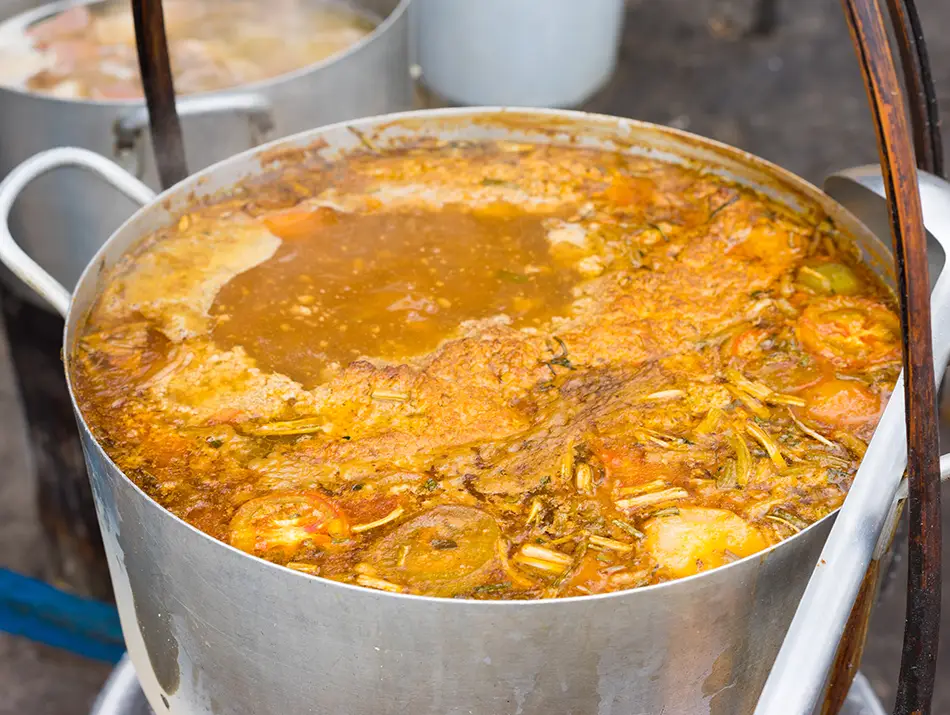 Tomato broth with crab paste curds, tofu and noodles shows what to eat in Vietnam.